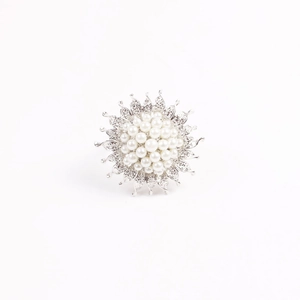 Close-up of pearl sunflower napkin ring with silver petals and sparkling crystals