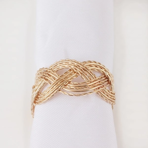 Golden infinity knot metal napkin ring with elegant braided design for table decor