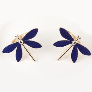 Elegant gold metal dragonfly napkin rings with deep blue enamel wings for table settings