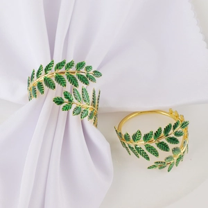 Elegant gold metal napkin rings with green enamel leaf design for wedding table decor