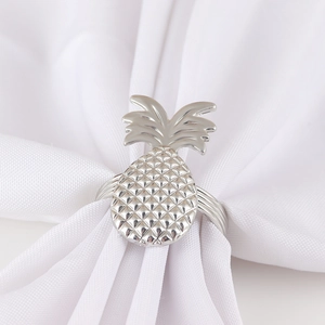 Silver pineapple napkin ring with textured fruit design and sleek metal band for decor