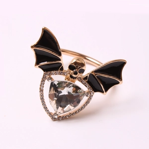 Macro shot of Gothic bat skull napkin ring with gold plating and triangular rhinestone detail