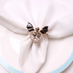 Halloween bat and skull napkin ring with clear crystal and black enamel on white napkin