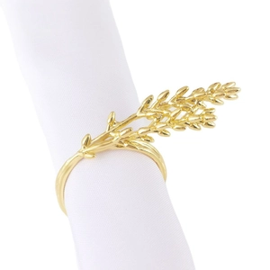 Elegant gold electroplated wheat ear napkin ring on white fabric for table decoration
