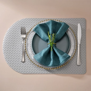 Golden lily of the valley napkin ring with white pearls on a teal textured napkin cloth