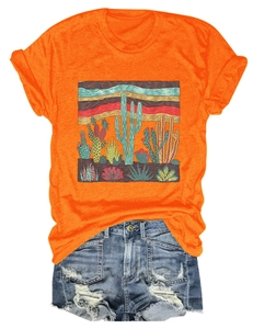 Flat lay of an orange cotton T-shirt with cactus print and distressed denim shorts