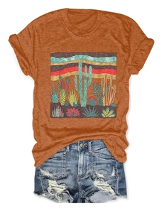 Flat lay of rust orange cactus print t-shirt and distressed denim shorts set