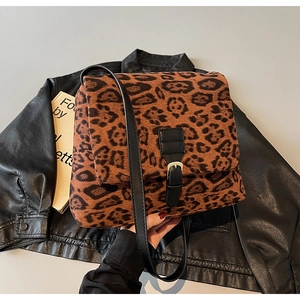 Detail of leopard print shoulder bag featuring suede texture and black leather strap