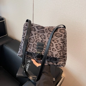 Vintage leopard print shoulder bag with black leather strap and metal buckle detail