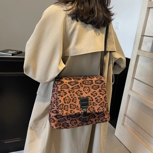 Chic leopard print crossbody bag with metal buckle shown with an autumn trench coat