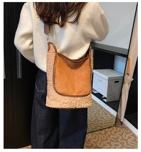 Close-up of brown suede and beige faux shearling patchwork detail on a shoulder bag