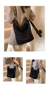 Detail of black suede hobo bucket bag with plush faux shearling trim and gold metal hardware
