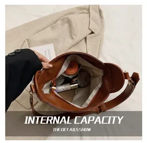 Interior view of brown faux leather bucket bag showing large capacity and zipper pocket