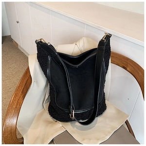 Detail of contrast bucket bag with sherpa trim on white coat for autumn style