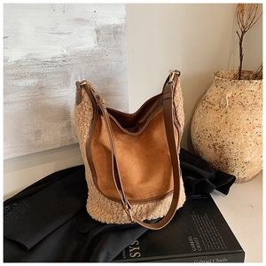 Detail of contrast bucket bag showing brown suede and cream faux shearling textures