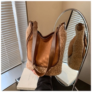 Detail of contrast bucket bag showing brown suede and beige faux shearling textures
