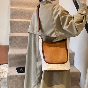 Contrast shearling bucket bag in brown and white with adjustable leather strap