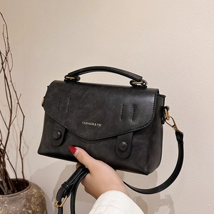 Retro black leather handbag with gold lettering and adjustable shoulder strap for women