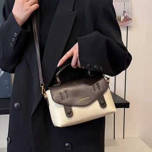Vintage style cream and brown leather crossbody bag with top handle and gold lettering