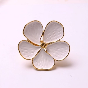 Elegant white enamel five-petal flower napkin ring with gold plated edges and textured petals
