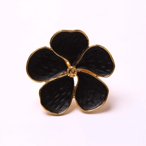 Floral napkin ring with black enamel petals and gold edging for wedding table decor