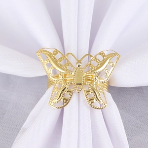 Elegant gold hollow butterfly napkin ring with intricate metal cutouts for table decor