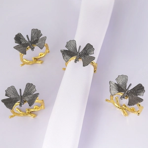 Set of four creative butterfly napkin rings with gold branch base for elegant table decor