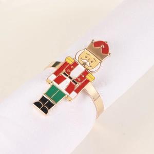 Detail of nutcracker soldier napkin ring on a white napkin for festive table settings