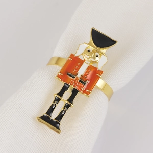 Close-up of Nutcracker napkin ring with red soldier detail and golden finish