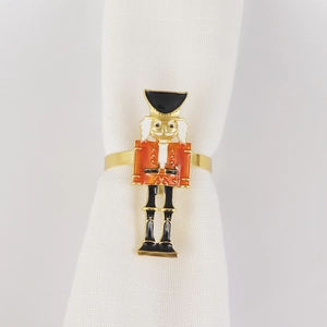 Detail of red and black nutcracker napkin ring on a white cloth for table setting