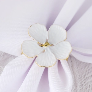 Elegant white enamel flower napkin ring with gold trim for wedding table settings