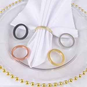 Close-up of elegant assorted metal napkin rings in gold silver and black finishes