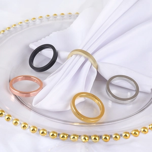Flat metallic napkin rings in black gold silver and rose gold on white linens