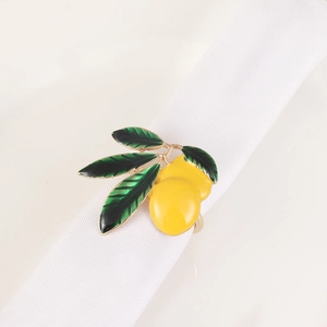 Close-up of a realistic yellow lemon napkin ring with green leaves on white linen