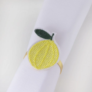 Handmade lemon napkin ring with yellow embroidery and golden metal loop for table decor