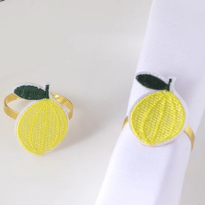Close-up of handmade embroidered lemon napkin ring with a polished golden metal loop