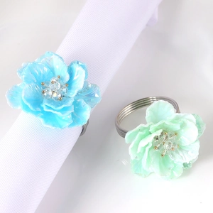 Floral acrylic napkin rings in sky blue and mint green with pearlescent resin petals
