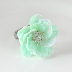 Mint green floral acrylic napkin ring with crystal accents on a silver metal loop