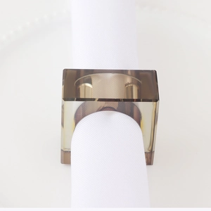 Modern charcoal gray resin napkin ring with geometric square design on a white plate