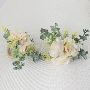 Close-up of pink rose napkin ring with green leaves and rustic woven jute band