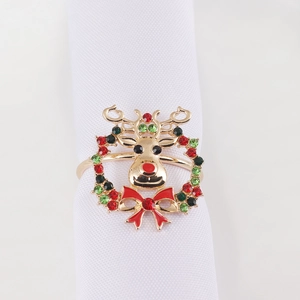 Detailed view of a gold Christmas reindeer napkin ring with red and green rhinestones