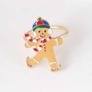 Christmas gingerbread man napkin ring in gold metal with festive colorful enamel detail