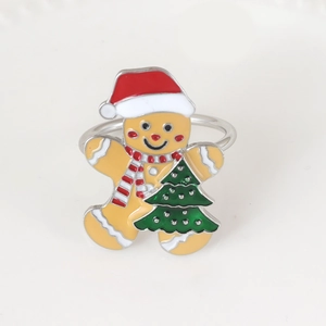 Detailed view of enamel gingerbread man napkin ring with a festive Christmas tree motif