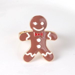 Christmas gingerbread man napkin ring with gold metal band and brown enamel finish