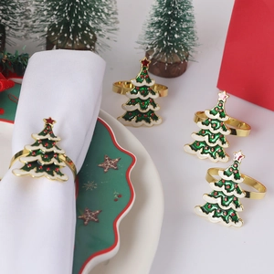 Close-up of a festive Christmas tree napkin ring with green enamel and red dots