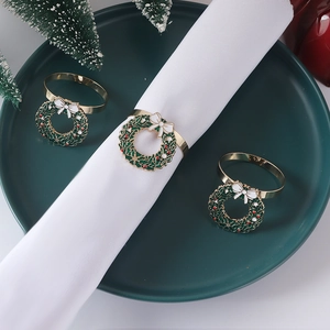 Christmas wreath napkin rings with green enamel and red berries for holiday table setting