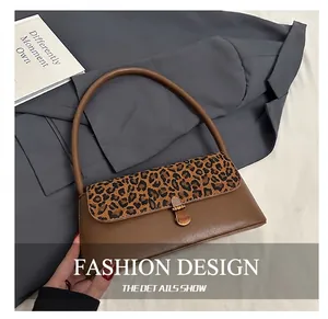 Detail showing vintage leopard print leather flap and golden oval twist lock of the handbag