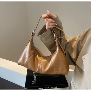 Brown vintage oil wax leather crescent shoulder bag with silver buckle and adjustable strap