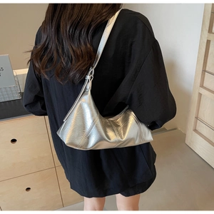 Side view of large silver crescent hobo bag with vintage oil wax leather texture