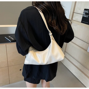 Rear view of model wearing a creamy white vintage crescent bag in soft oil wax leather